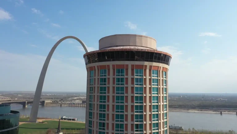 The former Millennium Hotel in St. Louis with the Gateway Arch in the background, showing the vacant tower slated for $670 million mixed-use redevelopment.