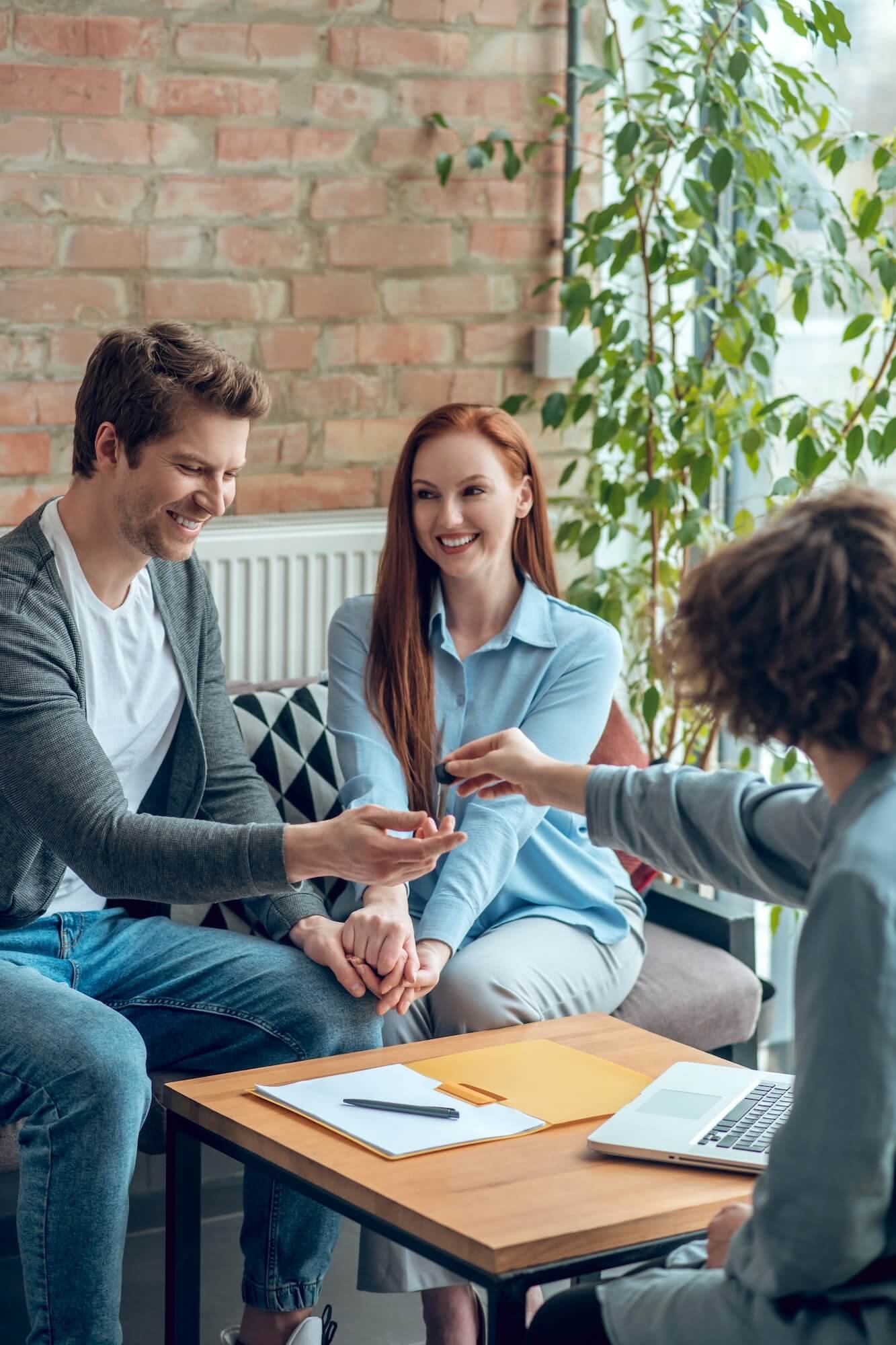 broker giving buyer real estate key 1