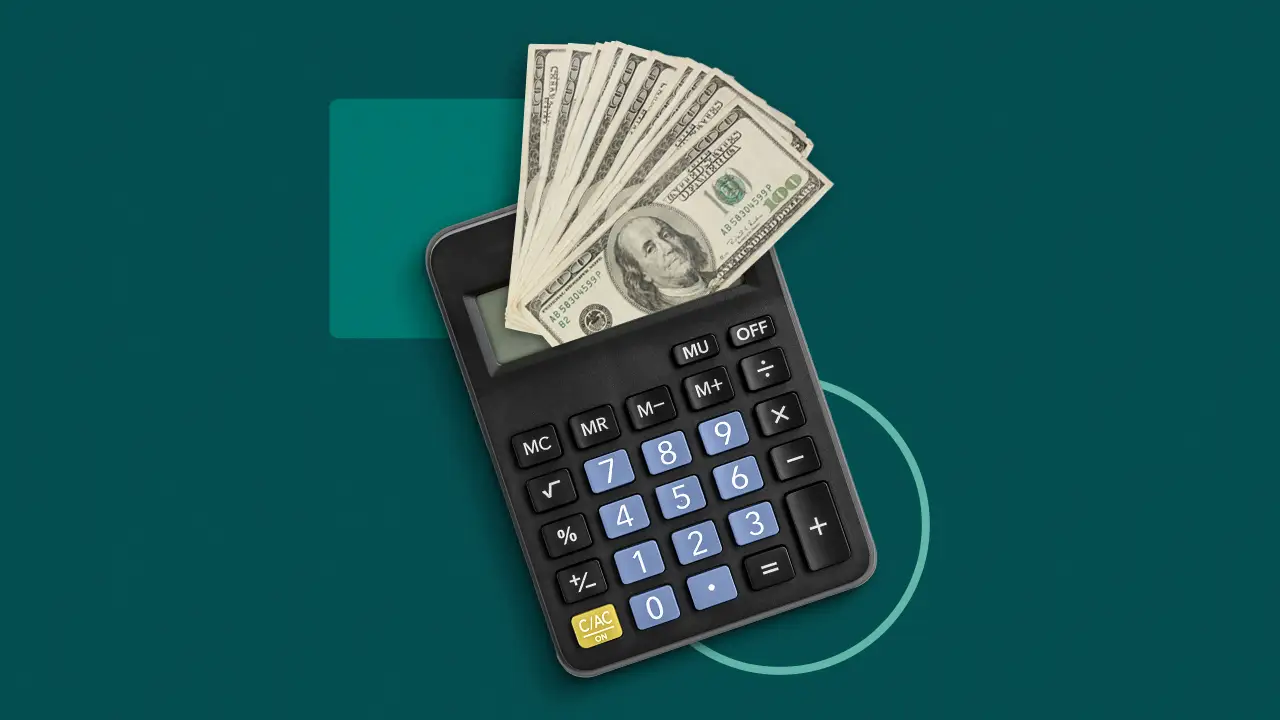 Calculator with US dollar bills symbolizing loan amount and mortgage calculation