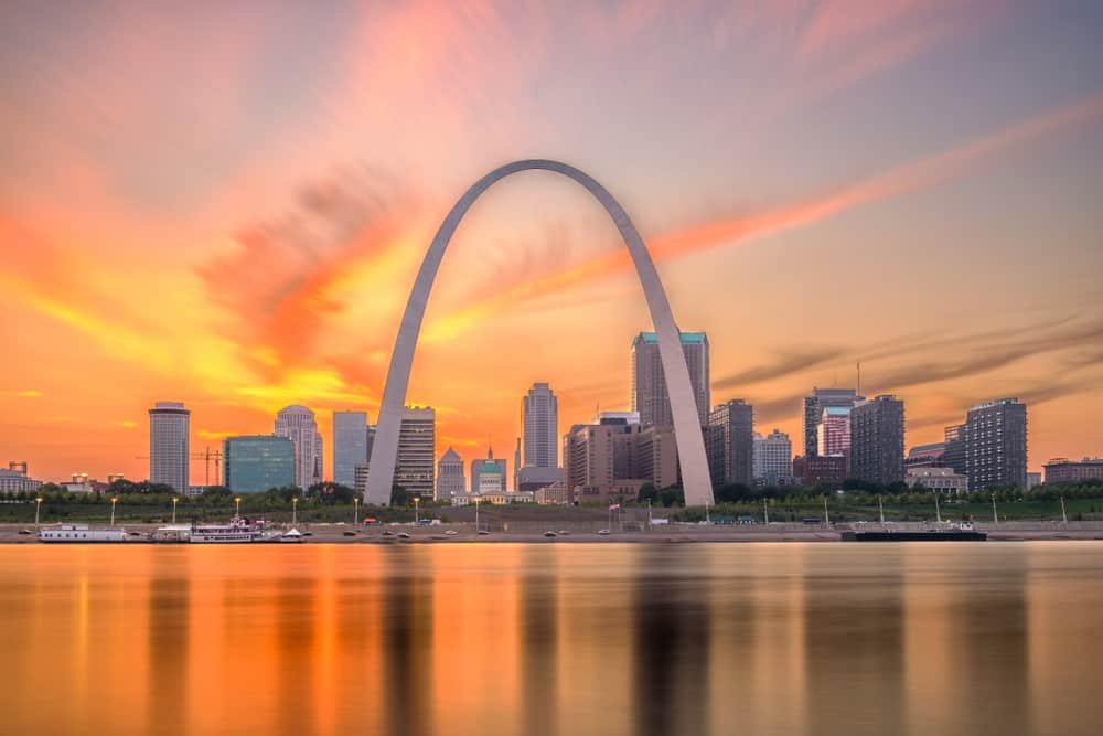 St. Louis skyline and Gateway Arch at sunset reflected on the Mississippi River - Moving to St. Louis Checklist