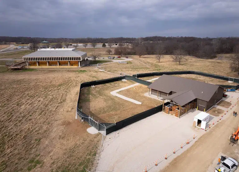 Aerial view of the St. Louis Zoo WildCare Park construction site in North St. Louis County, showing animal enclosures, support buildings, and ongoing development on repurposed golf course land.
