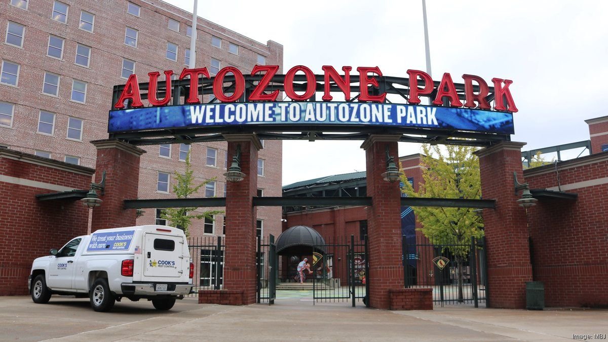 Front entrance of AutoZone Park in Memphis, featuring red signage and a digital welcome banner above the gate.