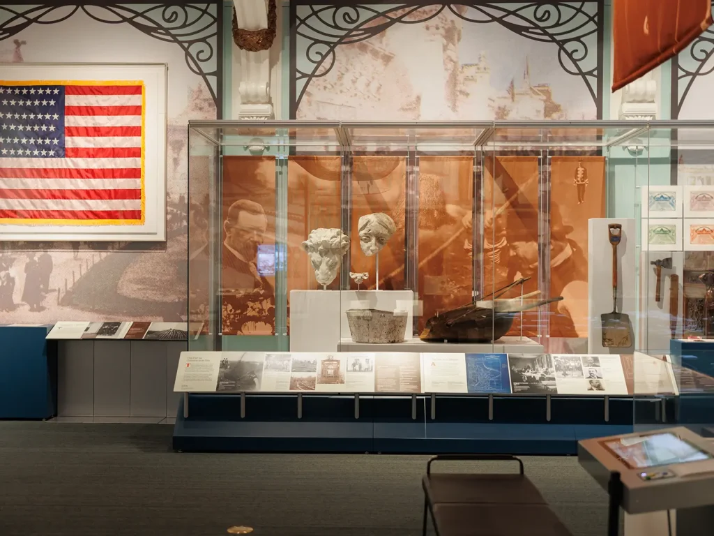 Exhibit display at the Missouri History Museum in St. Louis, featuring historical artifacts, an American flag, and educational signage for children and families.