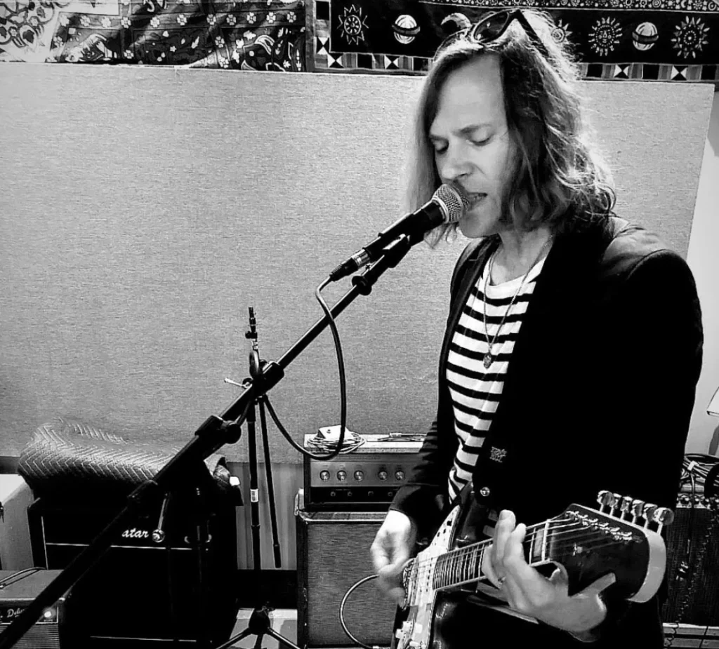 Kevin Bachmann of Summer Magic St. Louis band playing guitar and singing in the recording studio