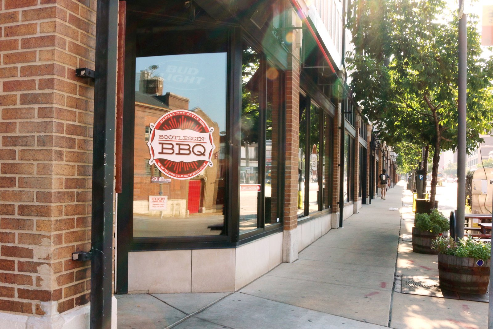 Exterior view of Bootleggin BBQ restaurant in St. Louis, featuring Kansas City–style BBQ signage on the front window.