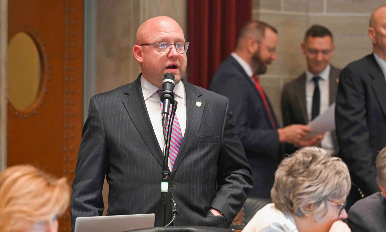 Missouri State Representative Chad Perkins speaking at the state Capitol during a legislative session.
