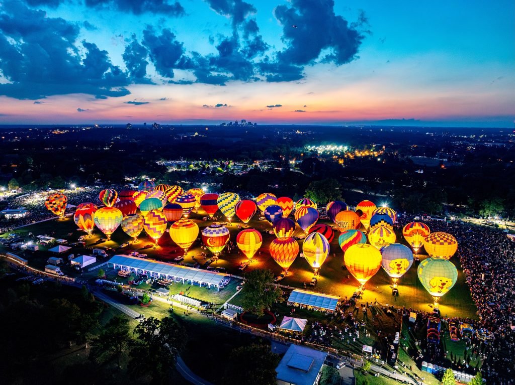 Hot air balloons glowing at dusk during the Great Forest Park Balloon Race in St. Louis, Missouri