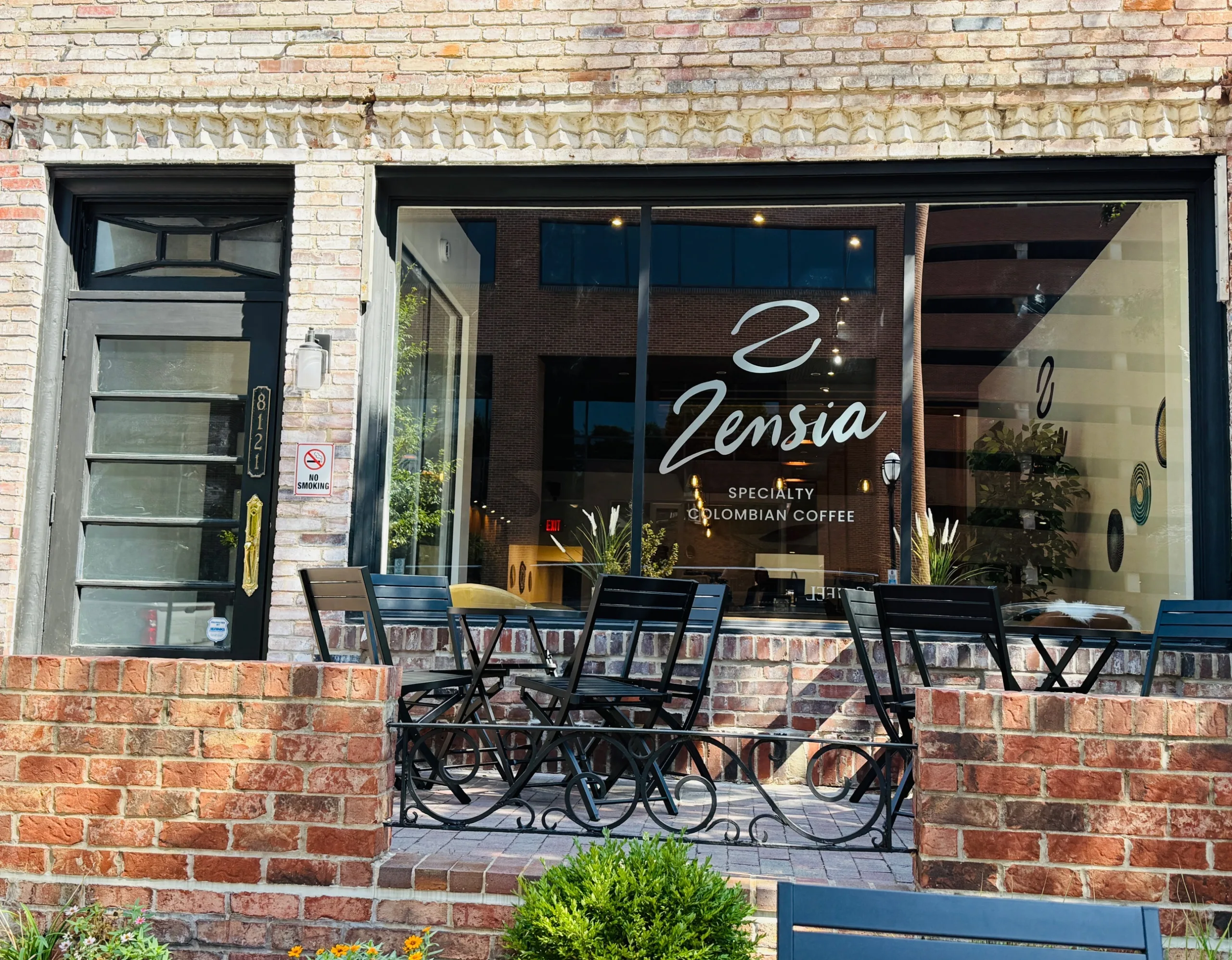 Exterior of Zensia coffee shop in Clayton, Missouri, featuring patio seating and specialty Colombian coffee signage at 8121 Maryland Avenue